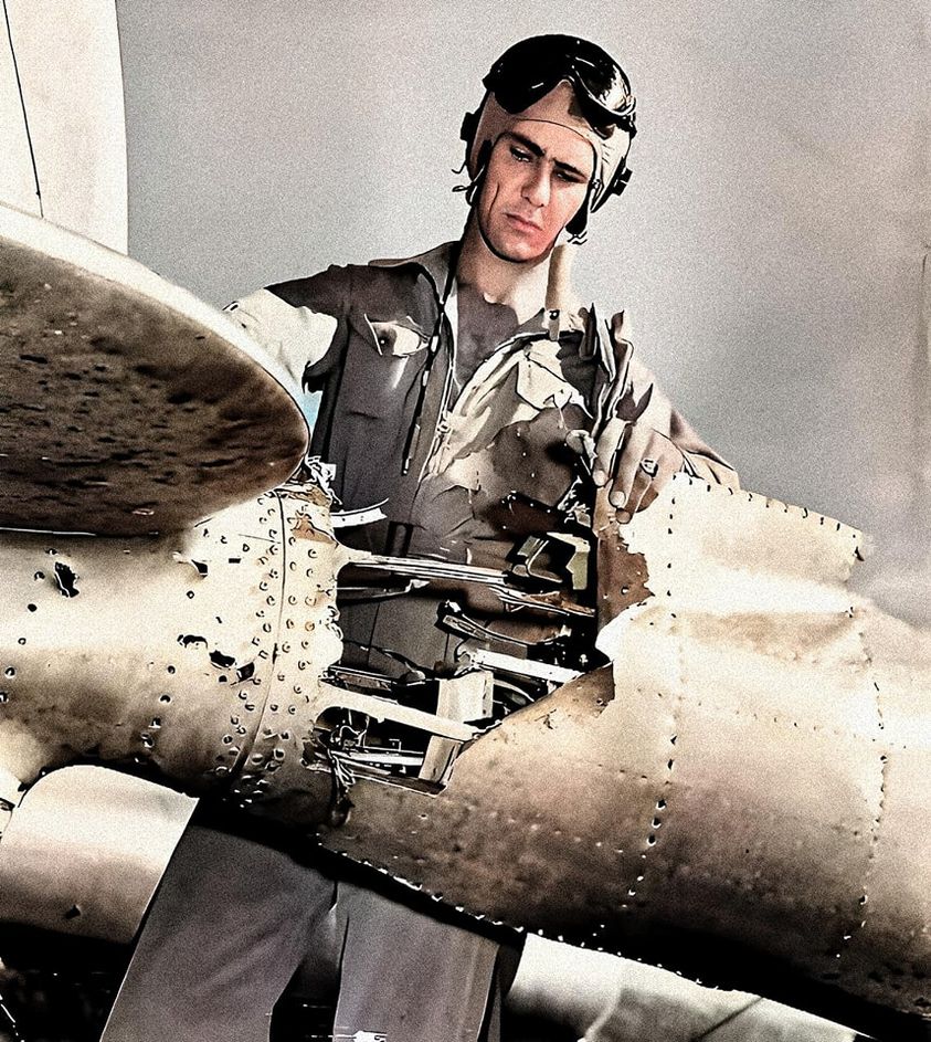 1Lt. Robert Amon examines the tail of his P-38G after being hit with FLAK..jpg