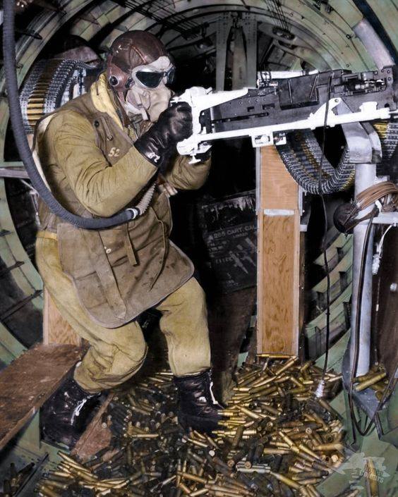 A waist gunner of a B-17 mans his .50-caliber machine gun. Gives you a great sense of the cram...jpg