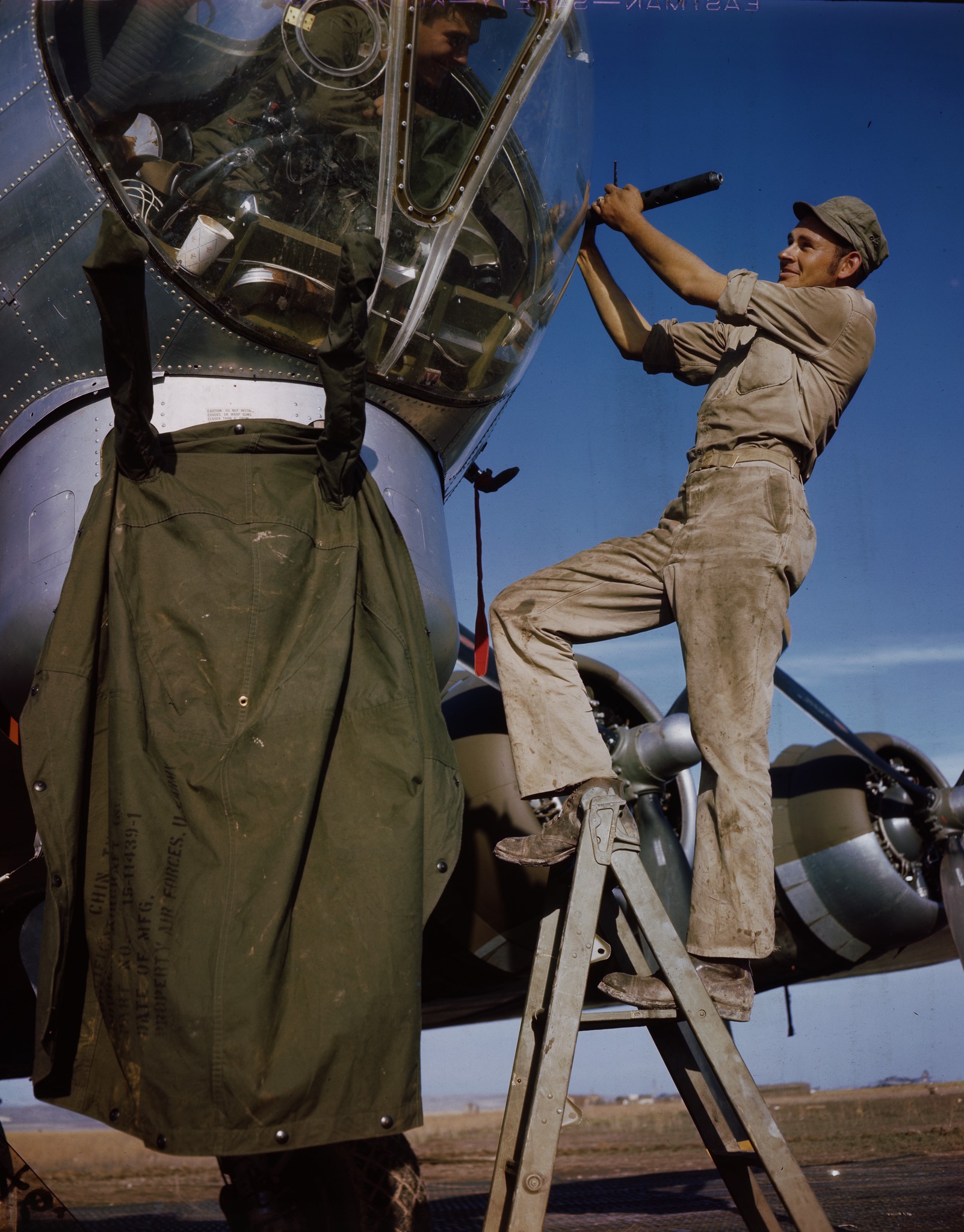 Corporal Walter Peck, Stanford, Kentucky, armament man, talking to gunner in nose of a B-17.jpg