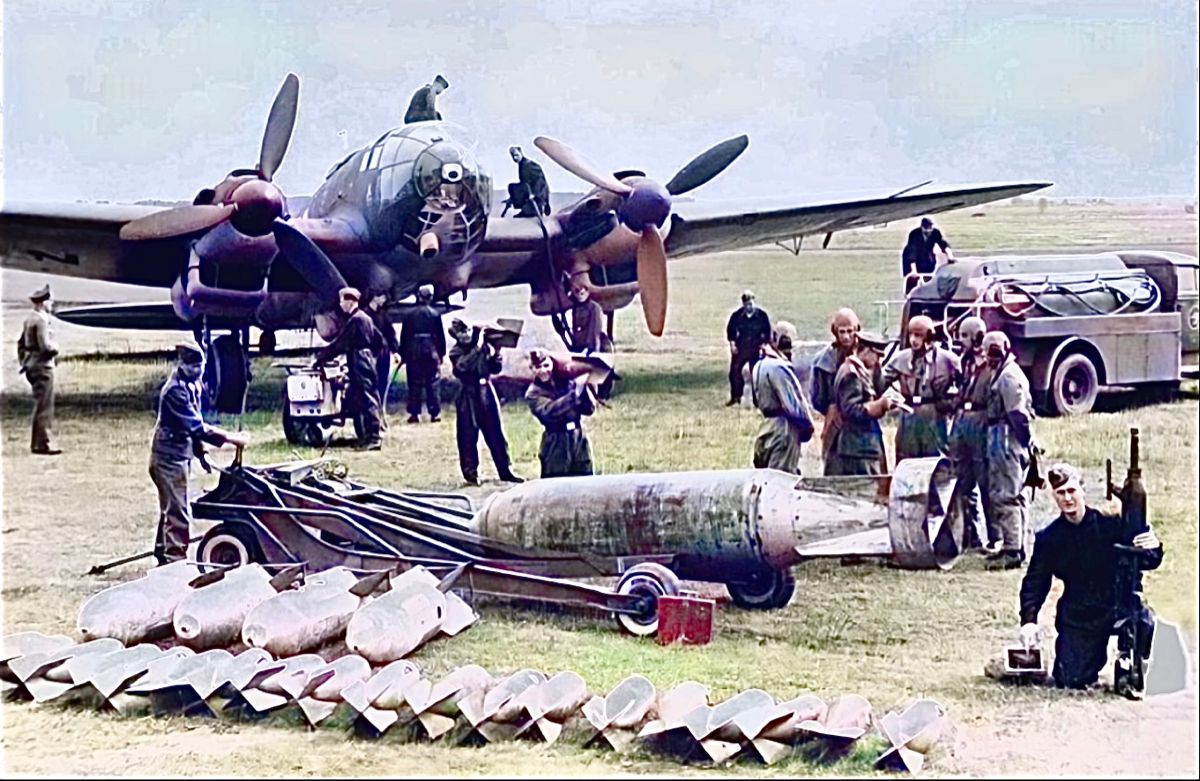 Heinkel He-111 being serviced while bomb load is prepared and air crew is breifed.jpg