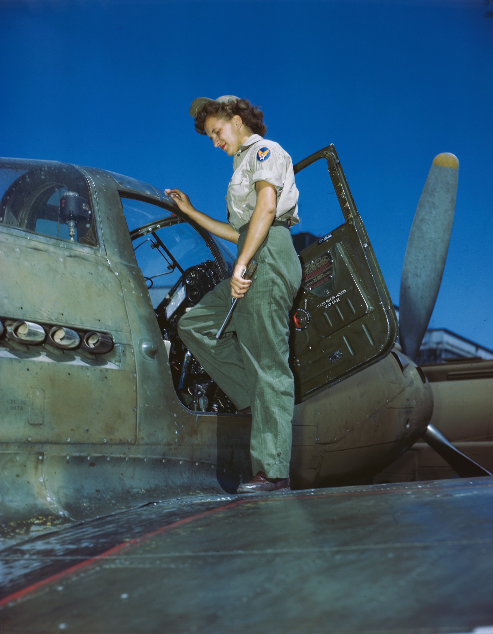 WAC mechanic entering cockpit of pursuit plane.jpg